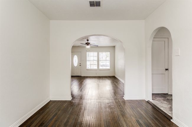 Entrance foyer featuring arched walkways, dark wood-type flooring, and ceiling fan | Image 8