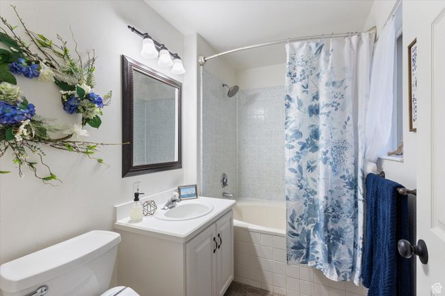 Bathroom featuring vanity, toilet, and tiled shower / bath combo | Image 14