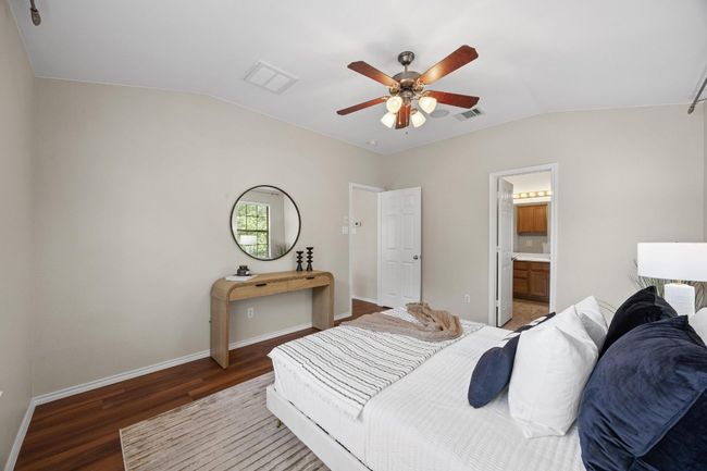 Bedroom with high ceiling, vinyl wood floors, ceiling fan, and ensuite bath | Image 23