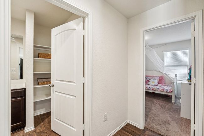 Corridor featuring baseboards and dark wood-style flooring | Image 12