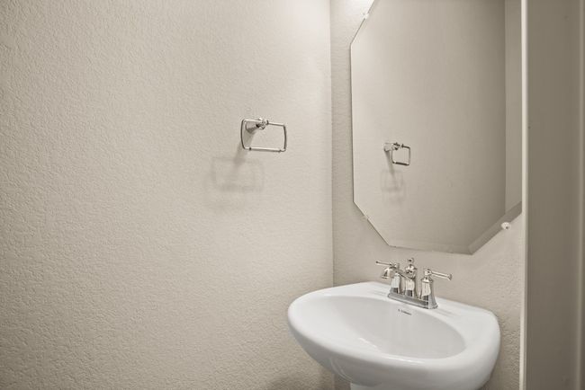 Bathroom featuring a sink and a textured wall | Image 29
