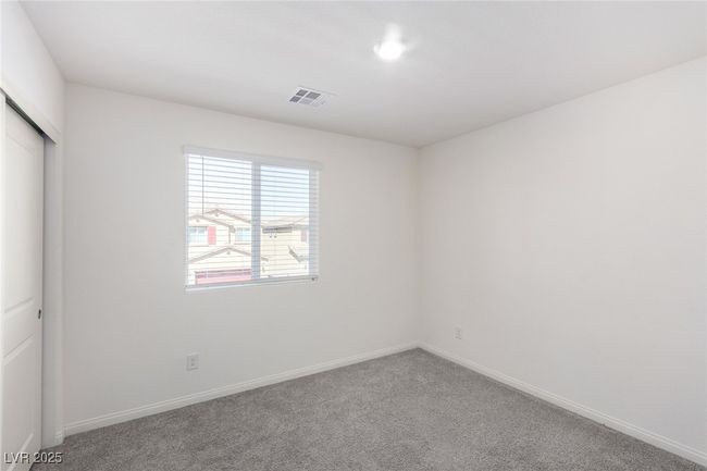 Unfurnished bedroom with a closet, baseboards, carpet, and visible vents | Image 24