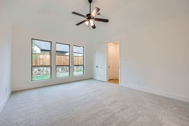 Unfurnished room with a ceiling fan, baseboards, visible vents, and light colored carpet | Image 14