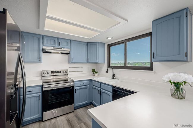Updated kitchen with new stove, refrigerator, vent hood and newly painted cabinets. | Image 11