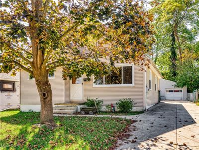 View of the front of the home with concrete driveway an oversized 2 car garage | Image 1