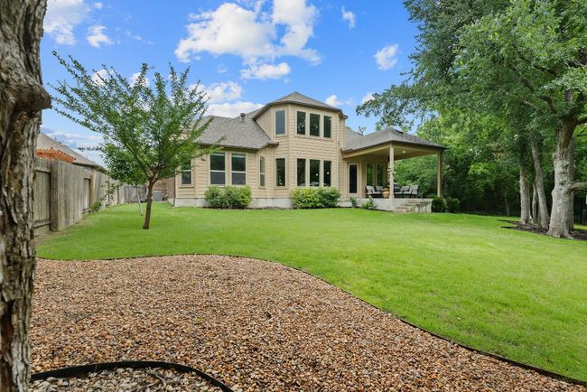 Back of house featuring a shingled roof and a patio | Image 36
