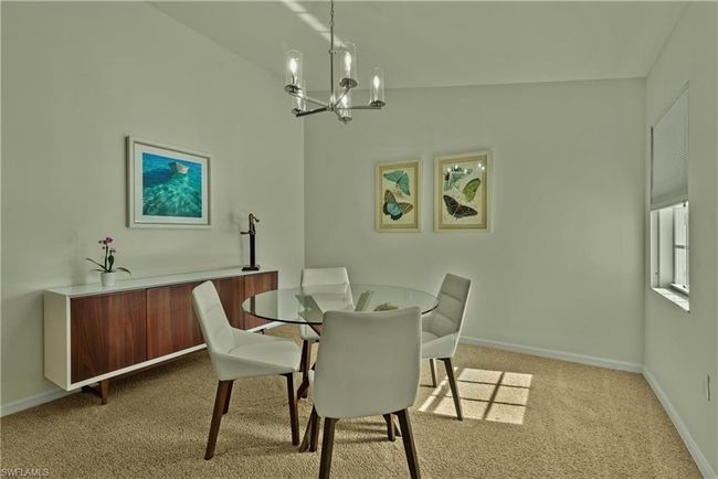 Carpeted dining area with vaulted ceiling and an inviting chandelier | Image 5