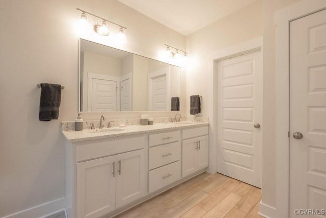Full bath featuring double vanity and wood finished floors | Image 18