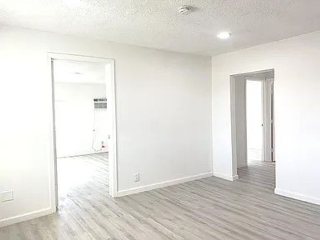 Spare room with wood finished floors and a textured ceiling | Image 4