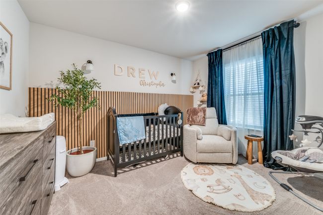 Bedroom featuring carpet floors and a crib | Image 18