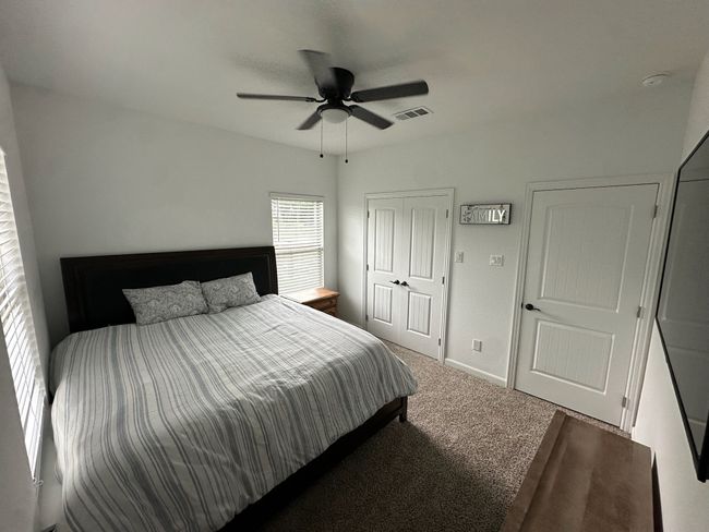 Living area with a raised ceiling, a ceiling fan, light wood finished floors, a fireplace, and recessed lighting | Image 10