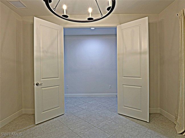 Empty room featuring light tile patterned flooring and baseboards | Image 26