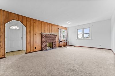 After greeted through an entry, gather in the living room illuminated with plenty of natural light. | Image 3