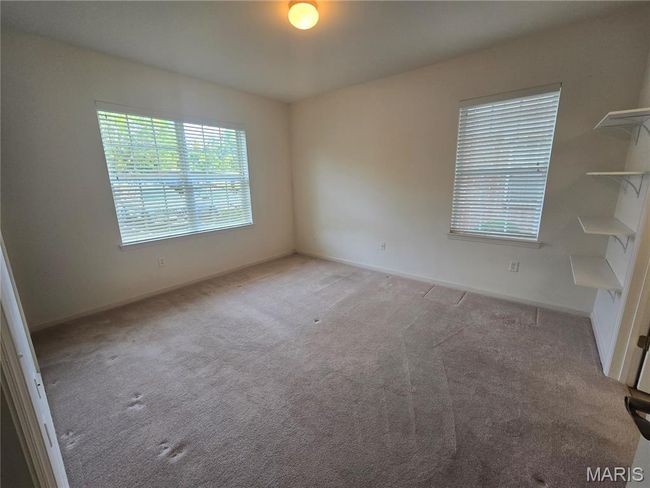 Primary bedroom with white 2" blinds on windows | Image 16