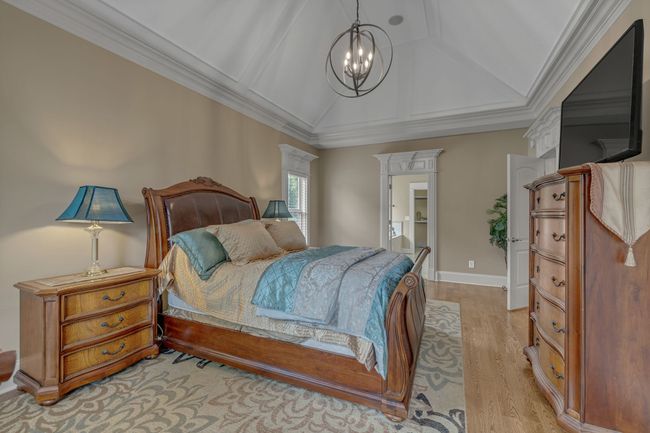 Spacious Primary Bedroom with hardwood and another awe-inspiring ceiling. | Image 22