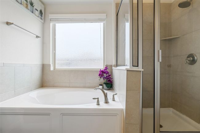 Bathroom featuring a bath and a shower stall | Image 18