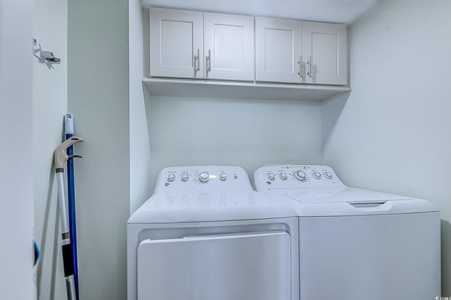 Laundry room with cabinets and washing machine and clothes dryer | Image 28