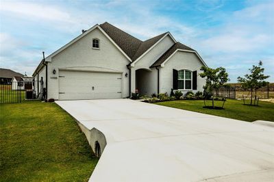 View of front of home featuring central air condition unit, a garage, and a front lawn | Image 3