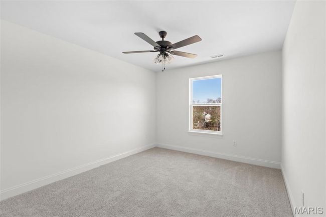Unfurnished room featuring light colored carpet and a ceiling fan | Image 12
