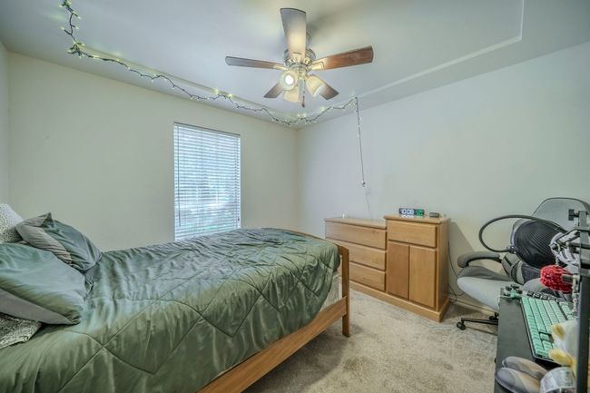 Bedroom featuring light carpet and a ceiling fan | Image 21