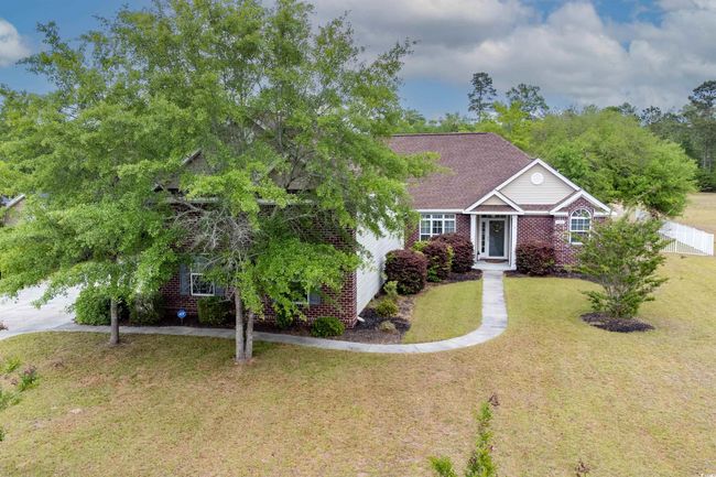 View of front of house featuring brick siding, a front yard, and fence | Image 31