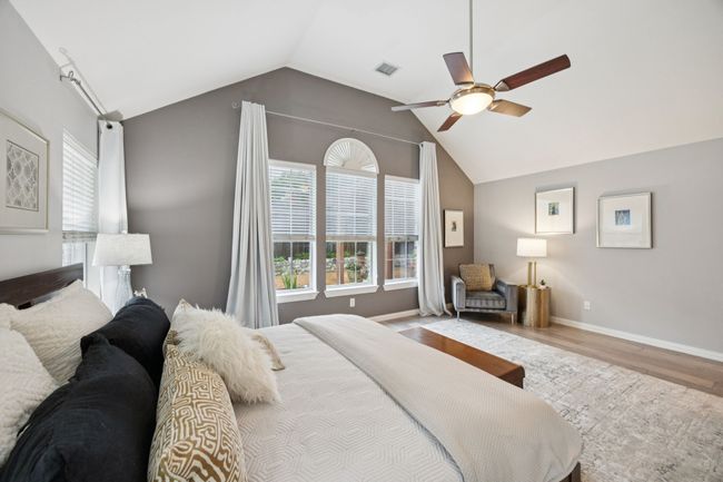 An angled view of the owner’s suite highlights the reading nook, natural light, and elevated ceilings—blending comfort and quiet charm. | Image 18