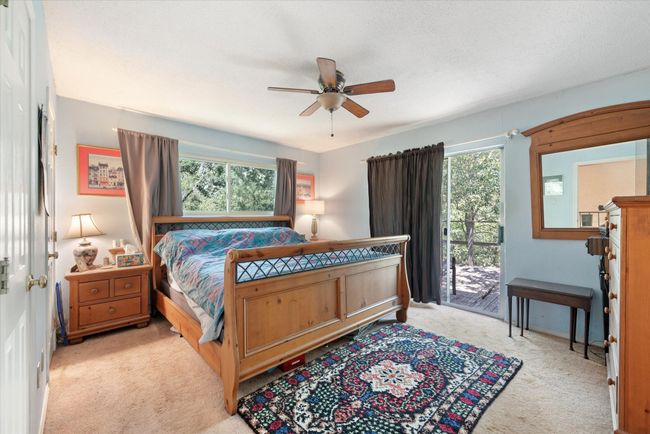 Bedroom featuring ceiling fan, access to exterior, and light colored carpet | Image 21