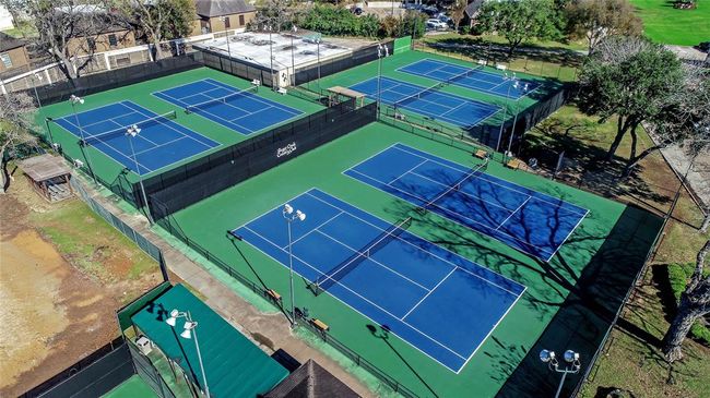 Stay active and enjoy friendly competition at the Sugar Creek Country Club’s premier tennis and pickleball facility! Featuring multiple well-maintained courts with professional lighting for evening play, this amenity is perfect for players of all skill levels. Whether you're sharpening your game or just enjoying a casual match, these courts provide a fantastic space to connect with neighbors and embrace an active lifestyle. | Image 49