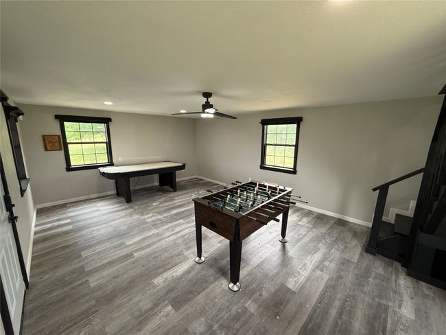 Recreation room featuring plenty of natural light, a ceiling fan, wood finished floors, pool table, and recessed lighting | Image 31