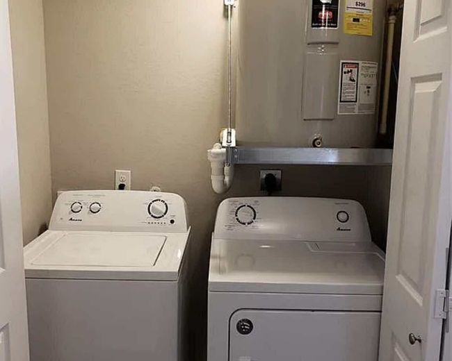 Laundry room with separate washer and dryer and electric water heater | Image 8