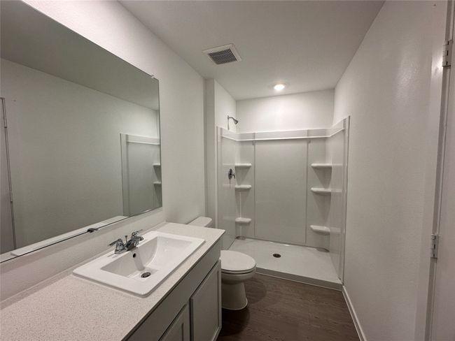 Bathroom featuring wood finished floors, a stall shower, and vanity | Image 14