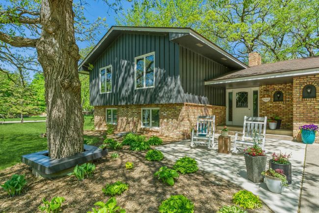 Adorable front patio is covered in shade and is perfect for relaxing, visiting or reading a good book! | Image 4