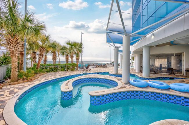 View of swimming pool featuring a fenced in pool, an in ground hot tub, and a patio area | Image 28