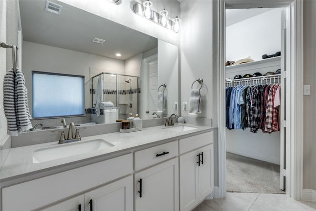 Full bath with tile patterned floors, visible vents, a sink, and a shower stall | Image 16