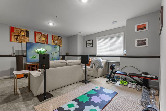 Daylight flows through the windows in the lower level rec room. | Image 35