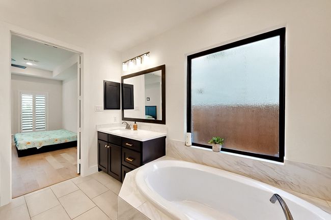 Ensuite bathroom featuring vanity, a bath, and tile patterned flooring | Image 20