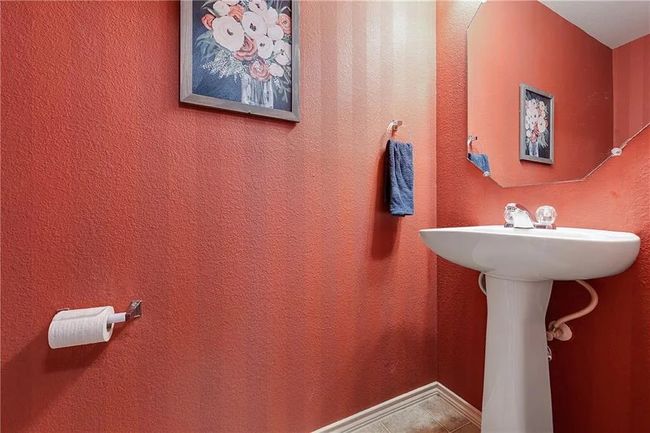 Bathroom with tile patterned flooring and a sink | Image 15