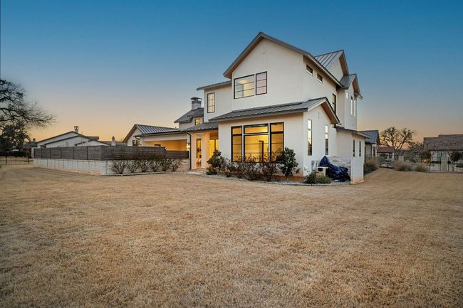 Back of house with metal roof, a yard, a standing seam roof, and fence | Image 34