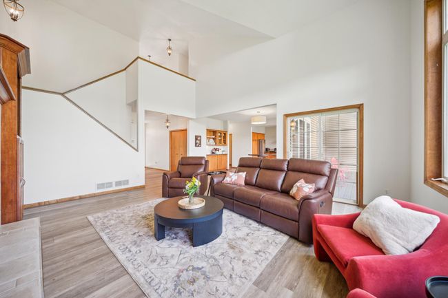 The main level features soaring vaulted ceilings and an abundance of windows that flood the space with natural light. | Image 9