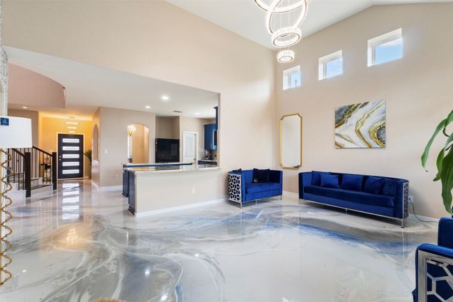 Building lobby with a high ceiling, stairs, and recessed lighting | Image 10
