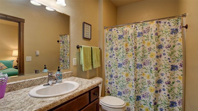 Guest Bathroom with tub/shower combo and access to the guest bedroom. Electric wall heater. | Image 10
