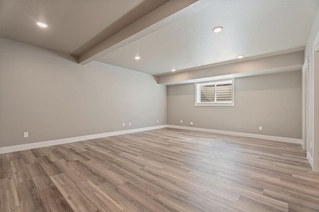 Finished below grade area featuring light wood-style flooring, baseboards, and recessed lighting | Image 31