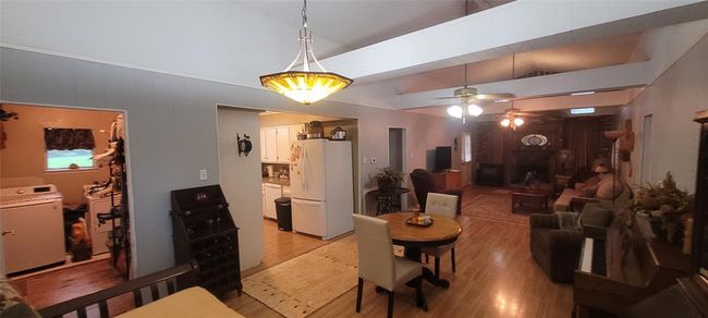 Living/dining room into laundry room and kitchen. | Image 17