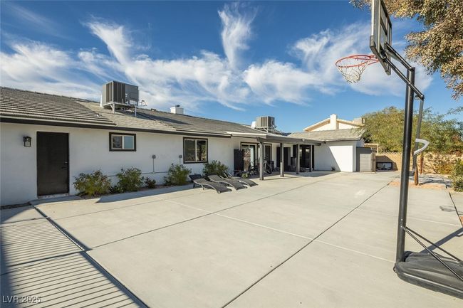 Back of house featuring a patio, central AC, and stucco siding | Image 34
