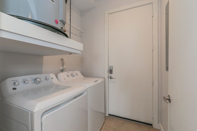 Washer and dryer included in a private utility area right off the entry—efficiency and ease built into your everyday. | Image 7