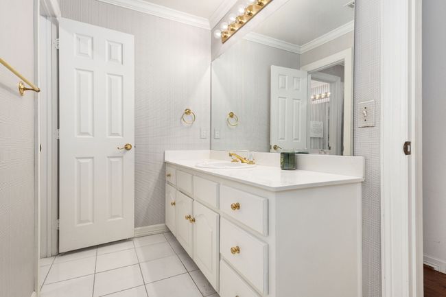 Bathroom featuring ornamental molding, vanity, and tile patterned floors | Image 23