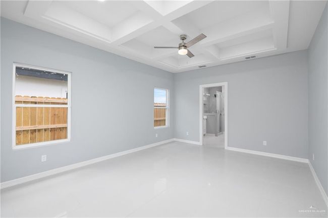 Unfurnished room with a ceiling fan, coffered ceiling, tile patterned flooring, and beam ceiling | Image 6
