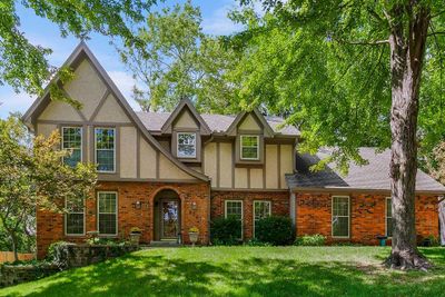 Tudor-style house with a front yard | Image 1