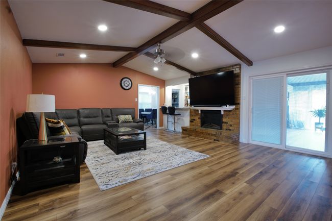 Living room with wood finished floors, ceiling fan, and recessed lighting | Image 7