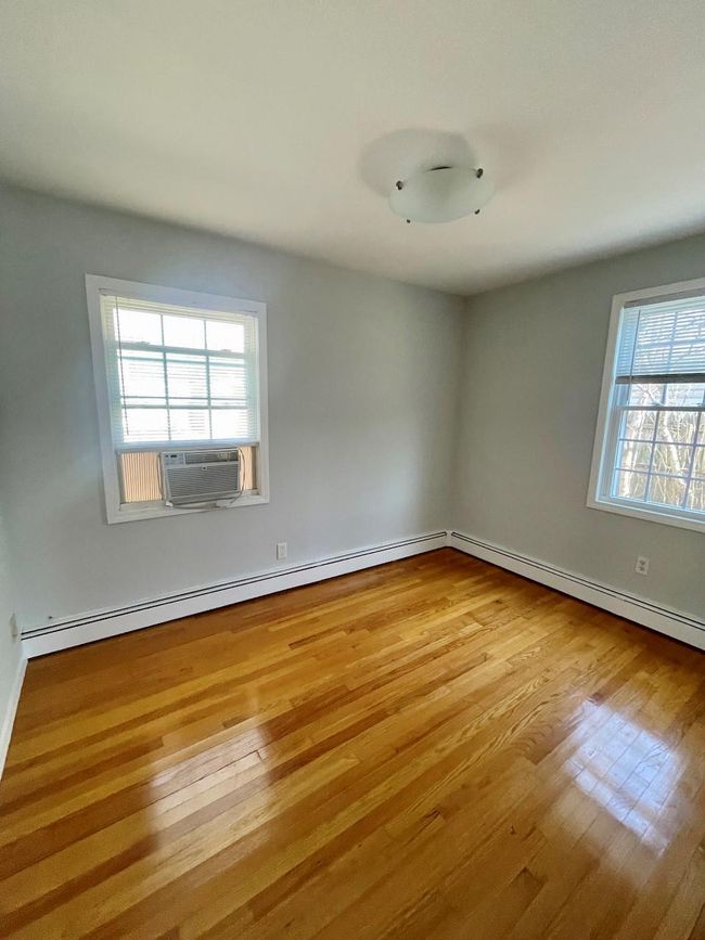 Spare room featuring baseboards, cooling unit, and wood finished floors | Image 21